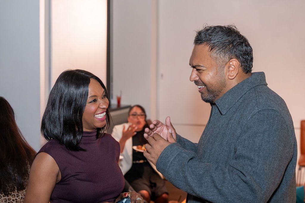 Two members greeting each other at the Unify Social 2026