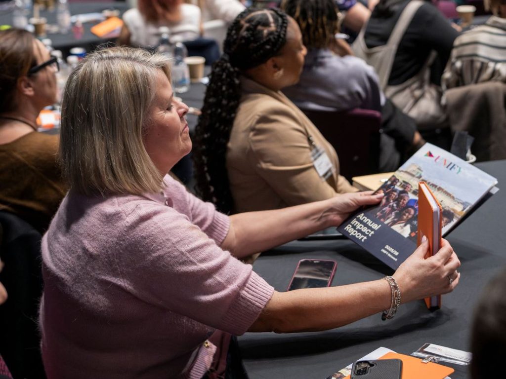 A delegate reading the conference programme